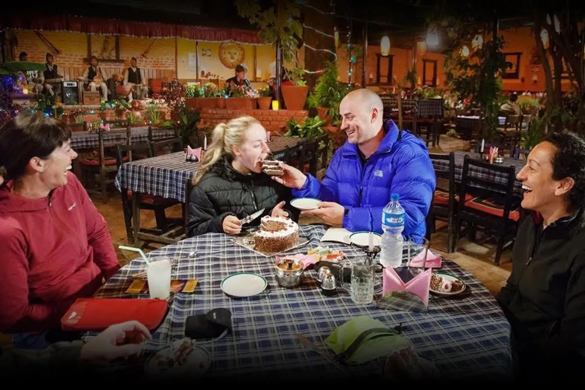 Guests sharing cake at Northfield Cafe with Gandharva musicians playing
