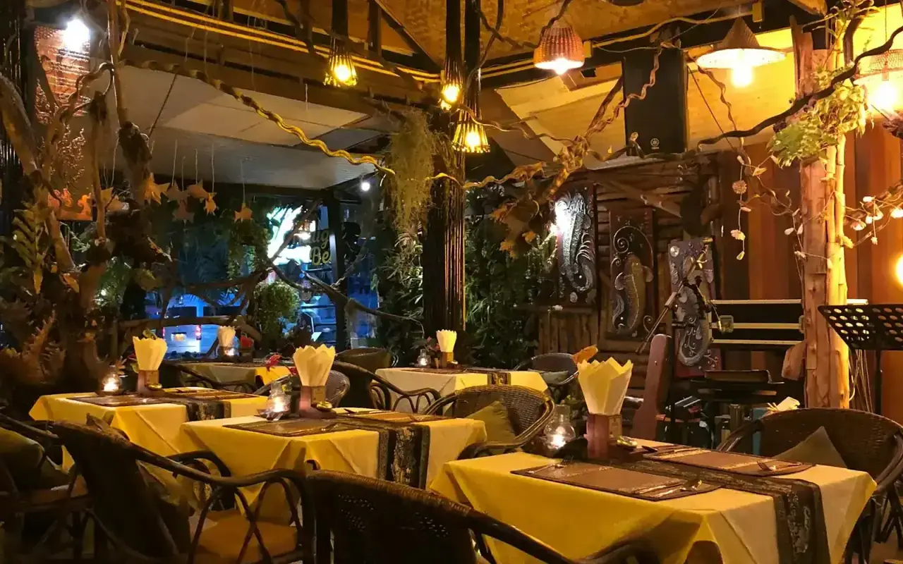 Northfield Cafe garden courtyard at dusk — Thamel, Kathmandu's oldest tourist restaurant since 1962, with live Gandharva music and fire pits